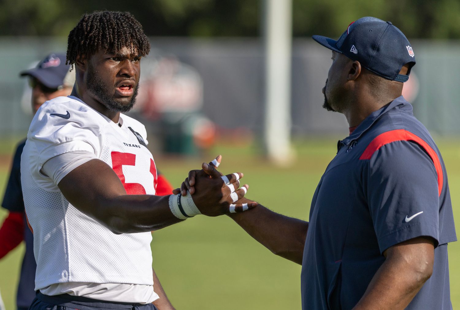 Houston Texans defensive end Will Anderson Jr. (51) shakes hands with a coach during training camp at the Houston Methodist Training Center.